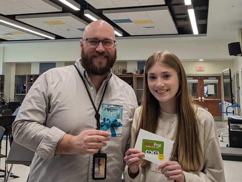 Cape Henlopen High School Band Director Christopher Burkhart, left, displays his gift card of appreciation from Johnson Orthodontics along with Lily Noonan, who nominated him for the prize drawing. SUBMITTED PHOTO